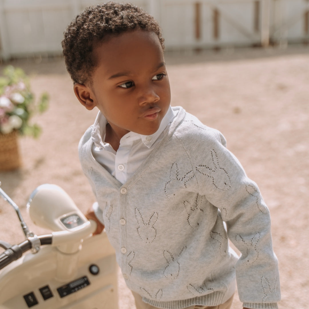 Baby boy in knitted cardigan